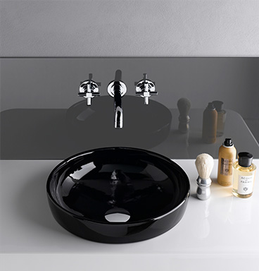 Black VitrA Water Jewels circular washbasin with chrome wall-mounted taps